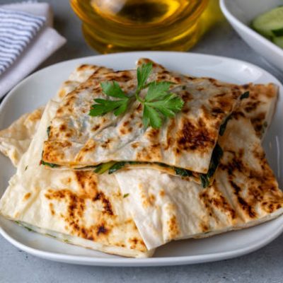 Traditional Turkish food, Turkish pancake gozleme with cheese and herb. The appetizer is Turkish pastry. There are varieties such as cheese, spinach, potato